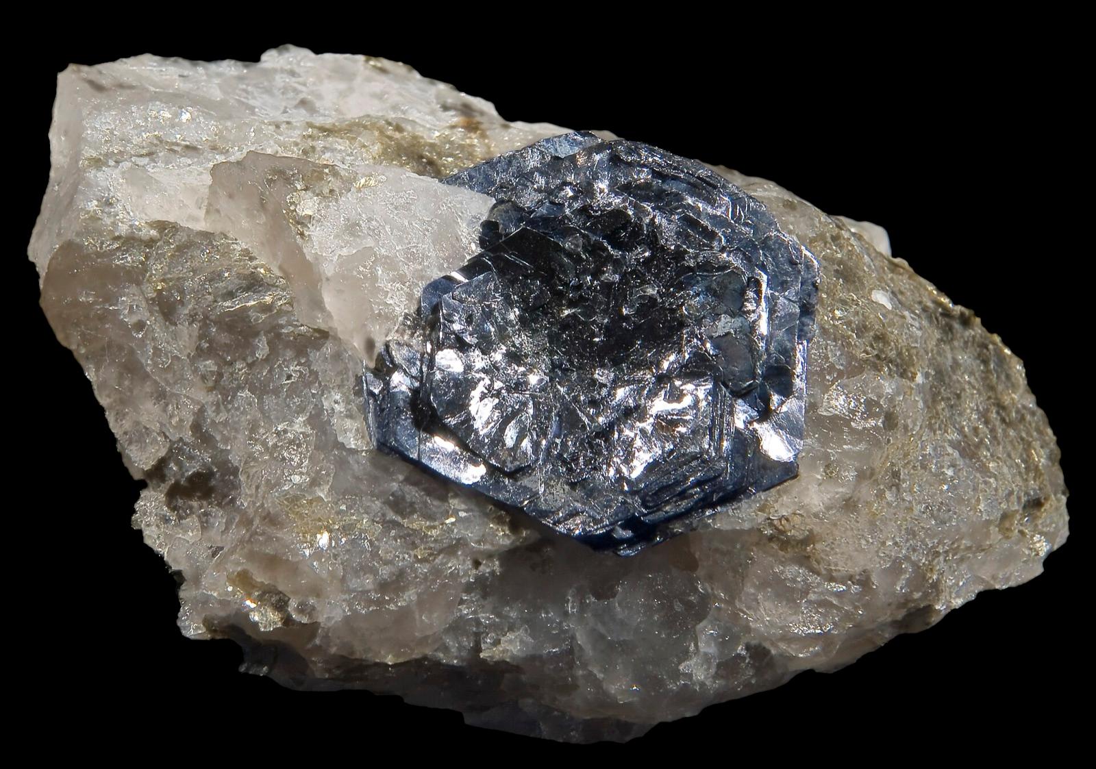 A silvery molybdenite crystal on quartz, like the molybdenite at the Catherine Mountain prospect