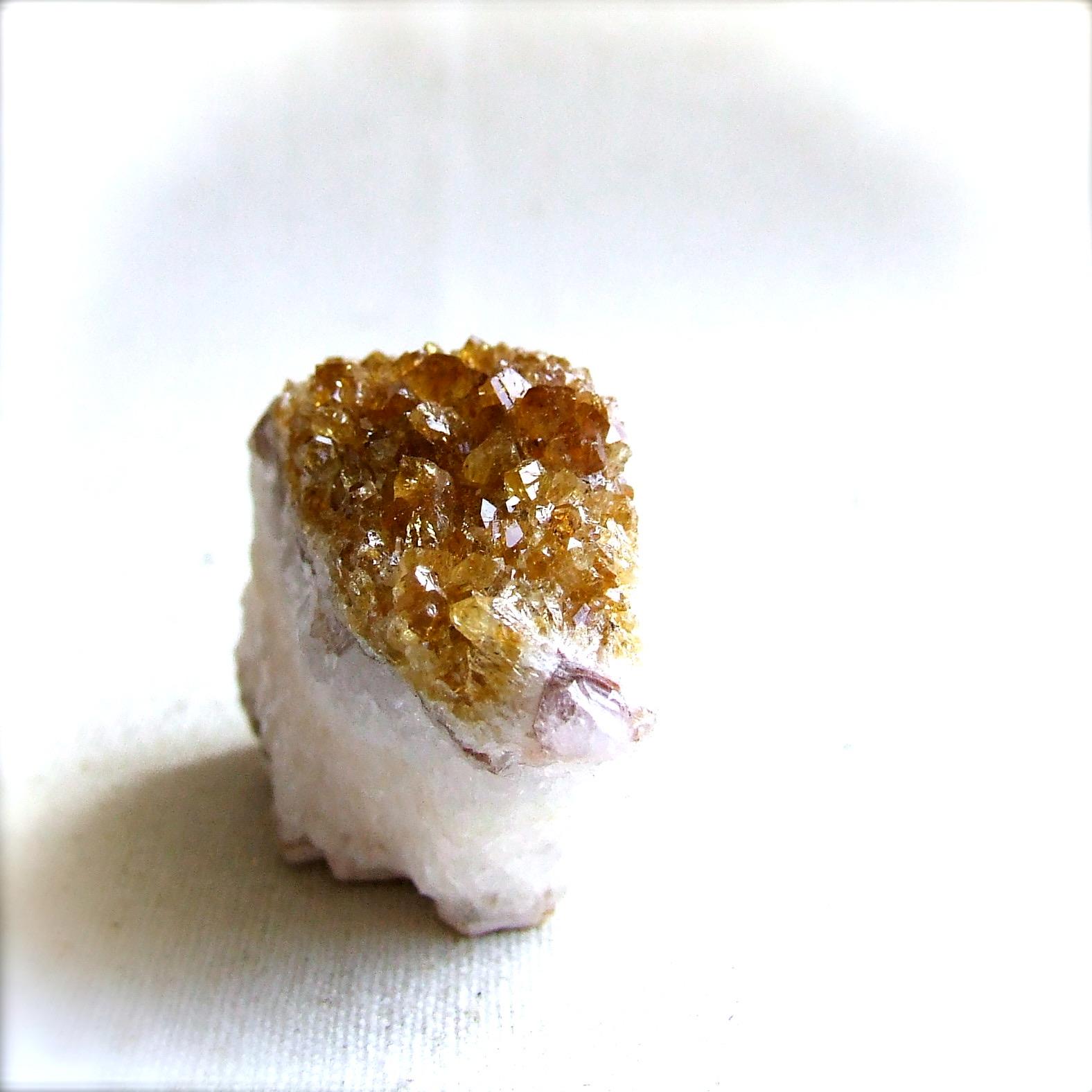 Citrine geode piece with golden-orange crystals over white quartz