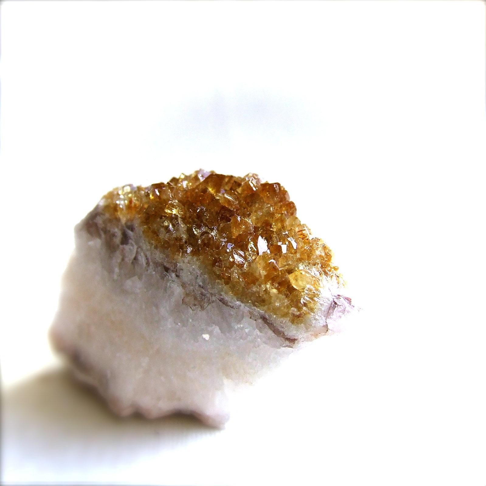 Side view of a citrine geode piece, crystal layer over a white quartz band