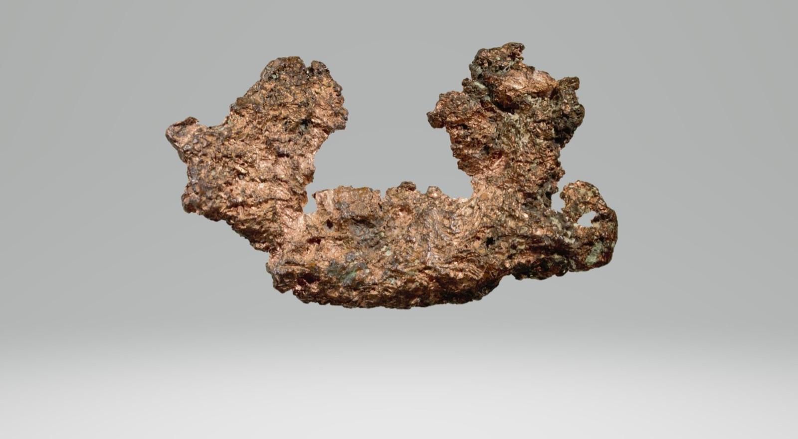 Raw copper nugget with spots of green patina