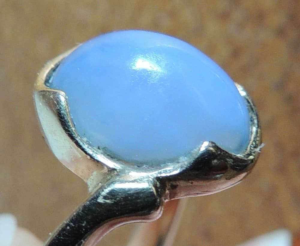 Pale cornflower-blue Ellensburg Blue agate cabochon, close view of the stone in its ring setting