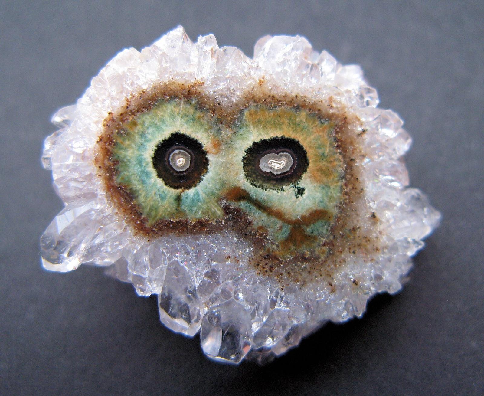 Eye agate slice with two concentric eyes ringed by quartz crystals