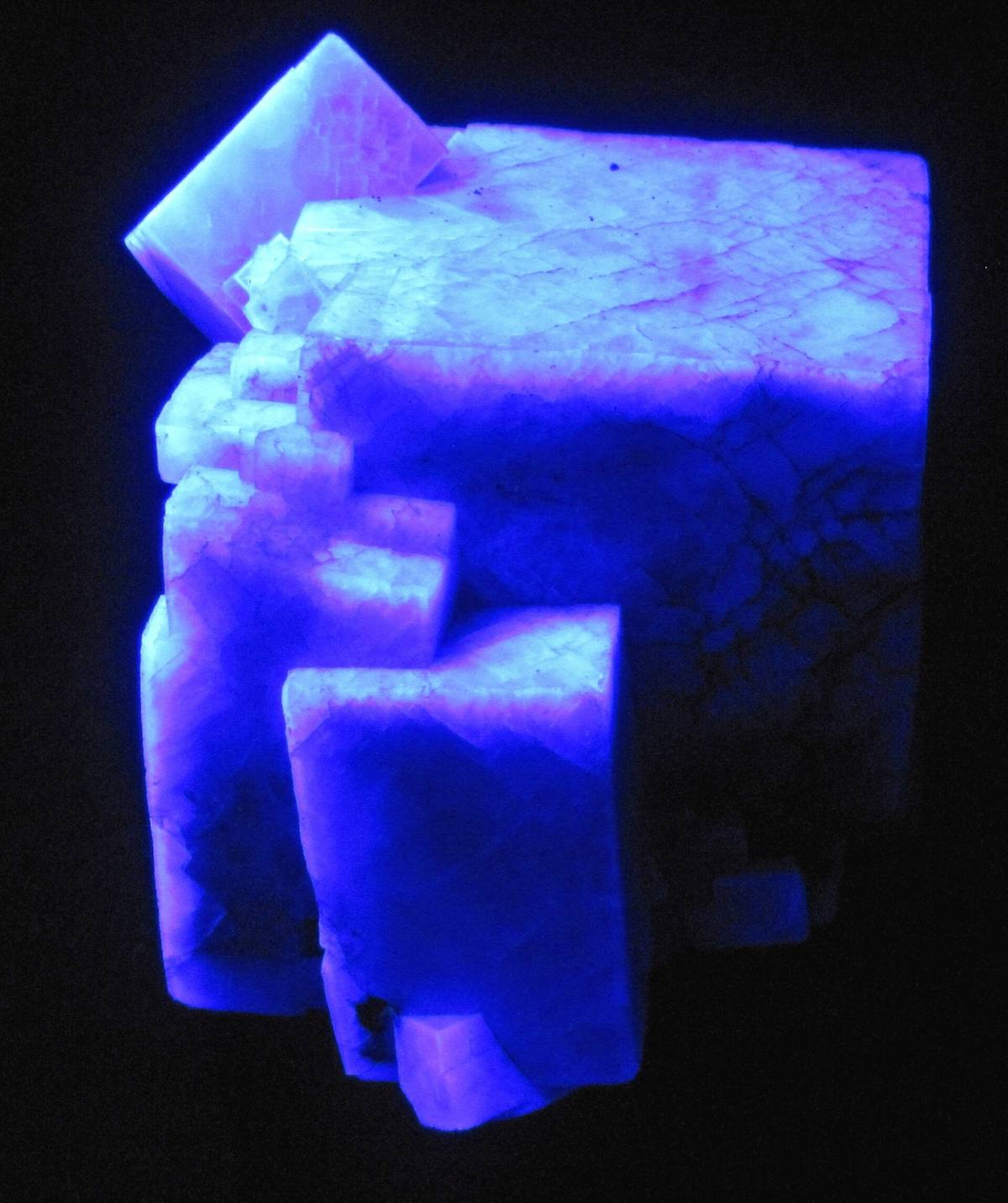Fluorite cubes fluorescing blue under ultraviolet light