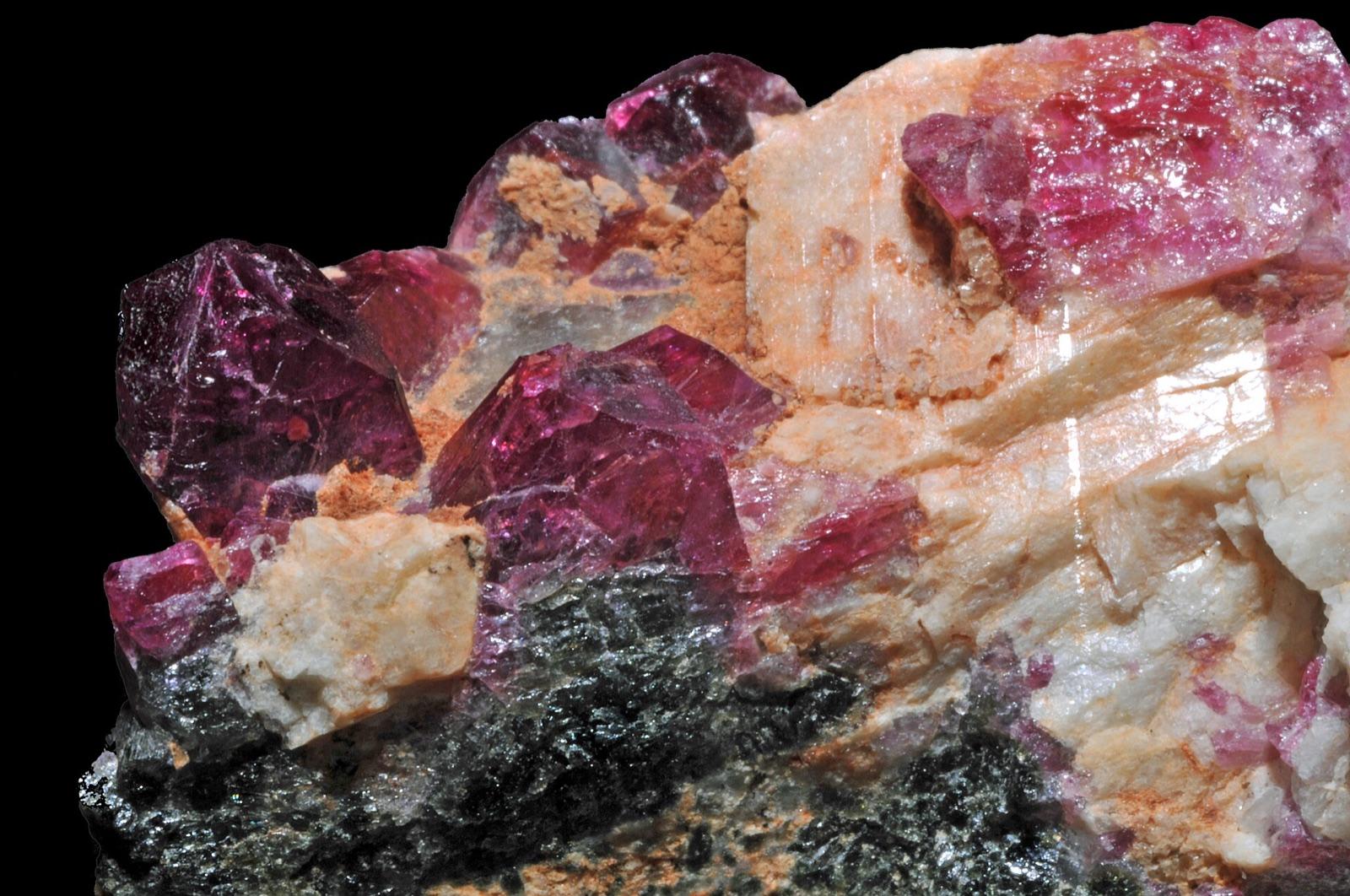 Pink to red liddicoatite crystals with microcline