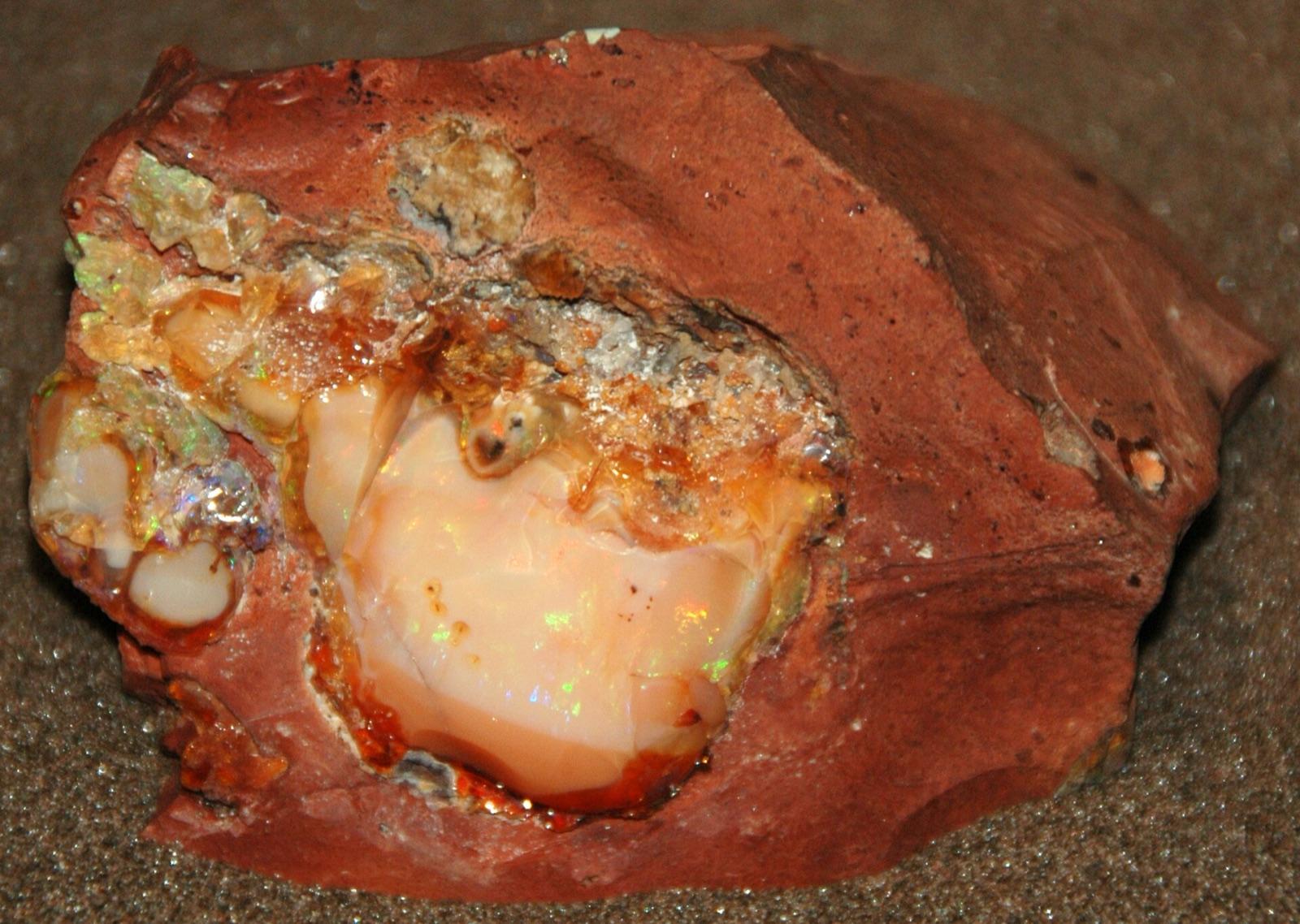 Precious opal in red rhyolite matrix from Mexico, Field Museum