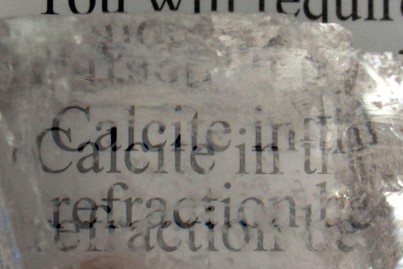 Text seen doubled through Iceland spar, showing its double refraction
