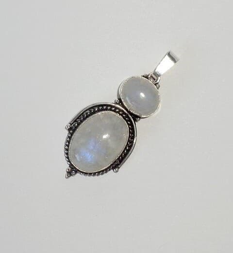 Rainbow moonstone (white labradorite) cabochons showing blue flash, set in a silver pendant