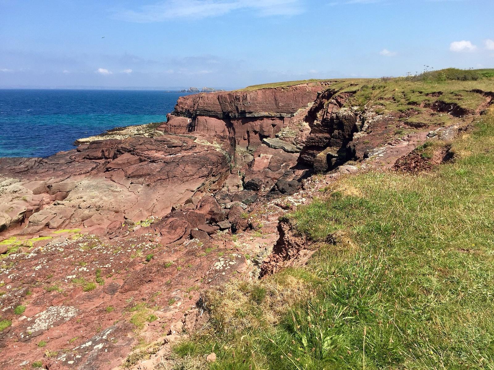 Red sandstone sea cliffs and ledges