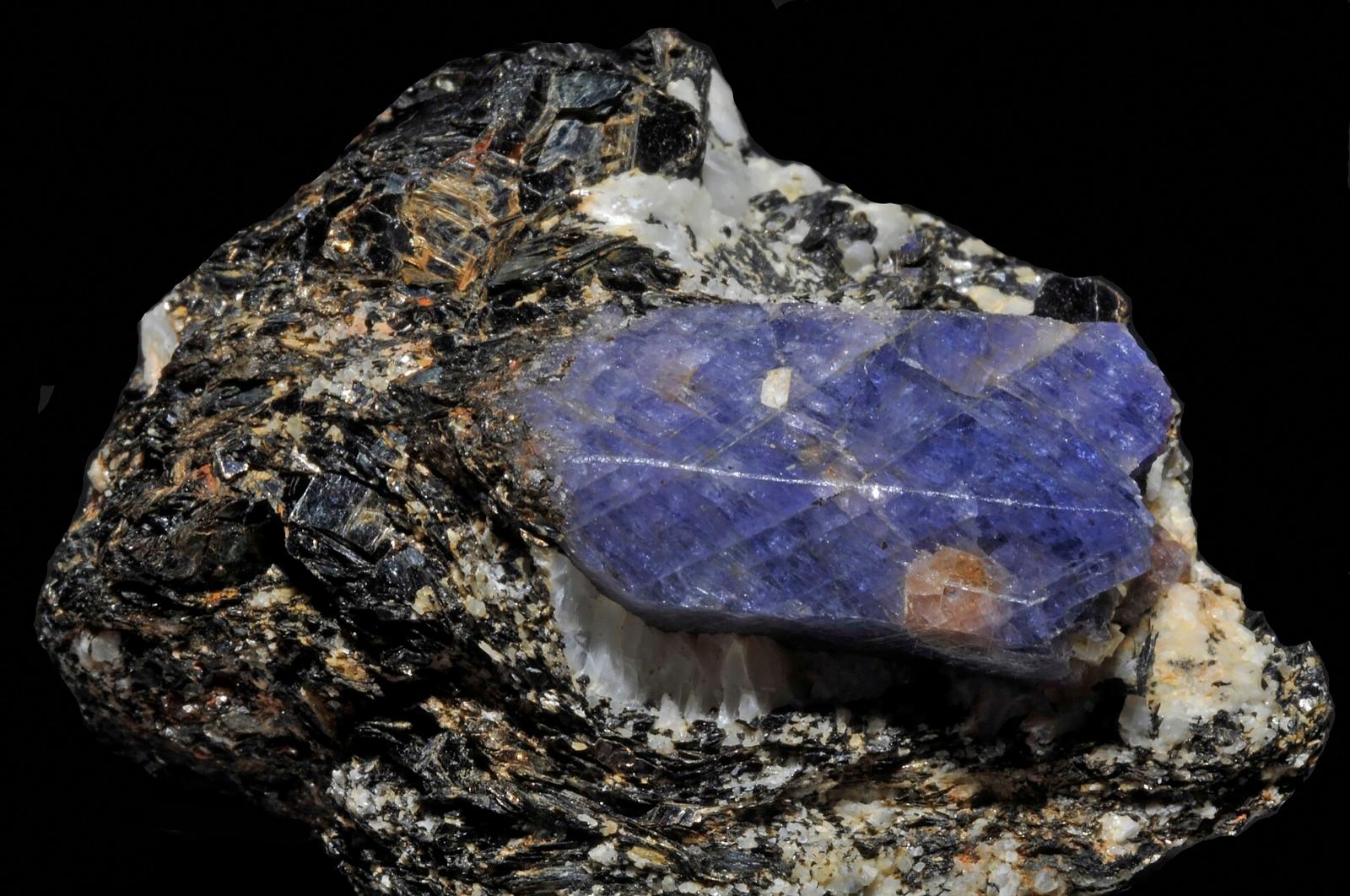 Blue sapphire crystal in dark biotite rock with amazonite, Zazafotsy quarry, Madagascar