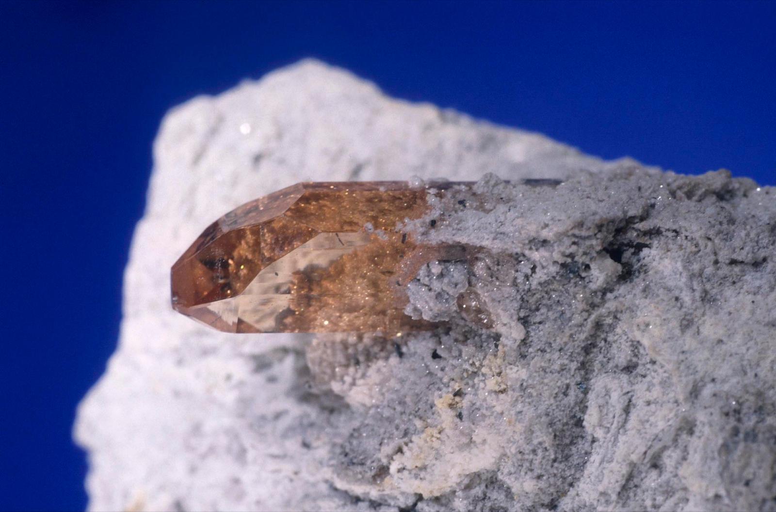 Sherry-brown topaz crystal on rhyolite, Thomas Range, Utah