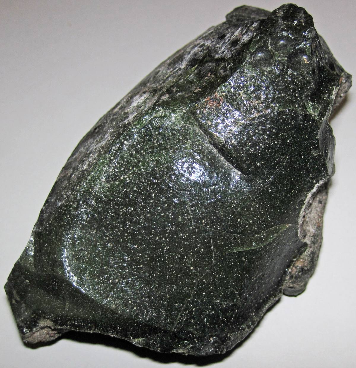 Dark green glassy smelter slag