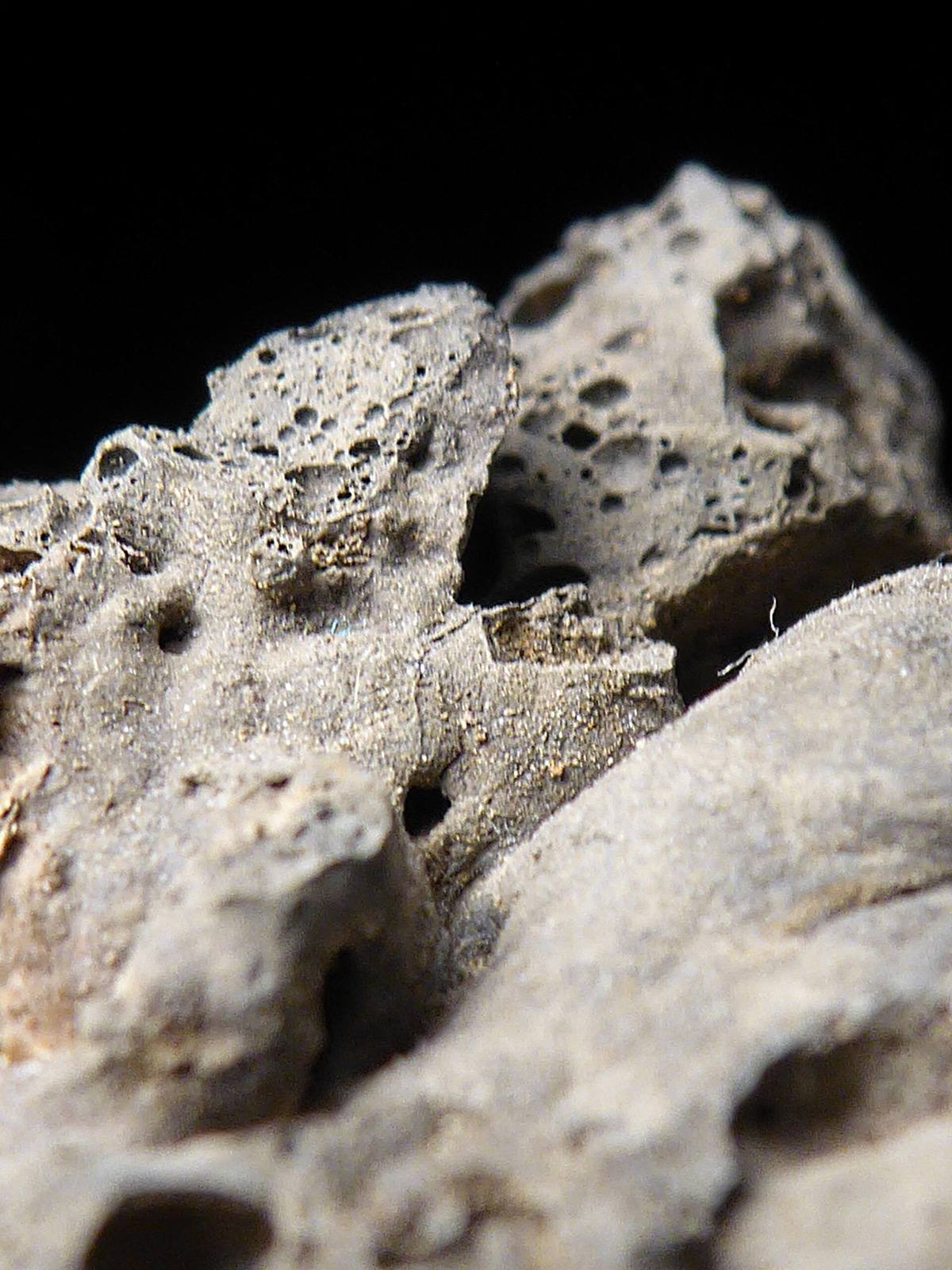 Vesicular grey slag showing the gas bubbles that distinguish it from meteorite