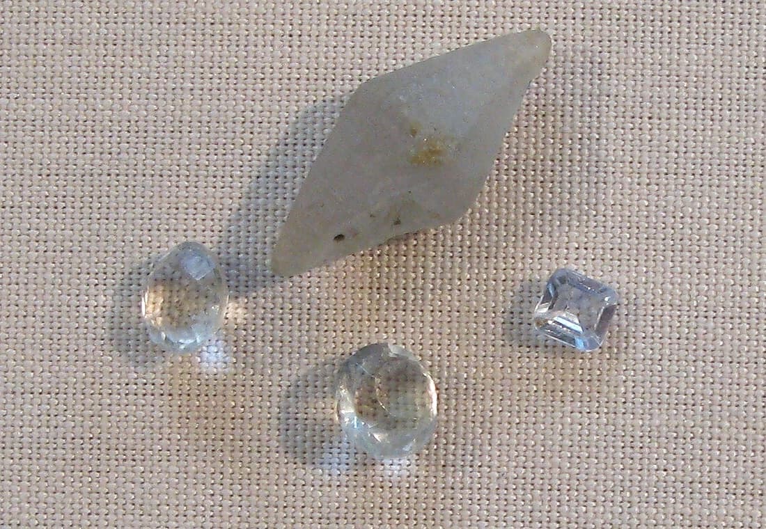 Colorless faceted white sapphires and a gray rough crystal from Sri Lanka, Mineralogical Museum, Bonn